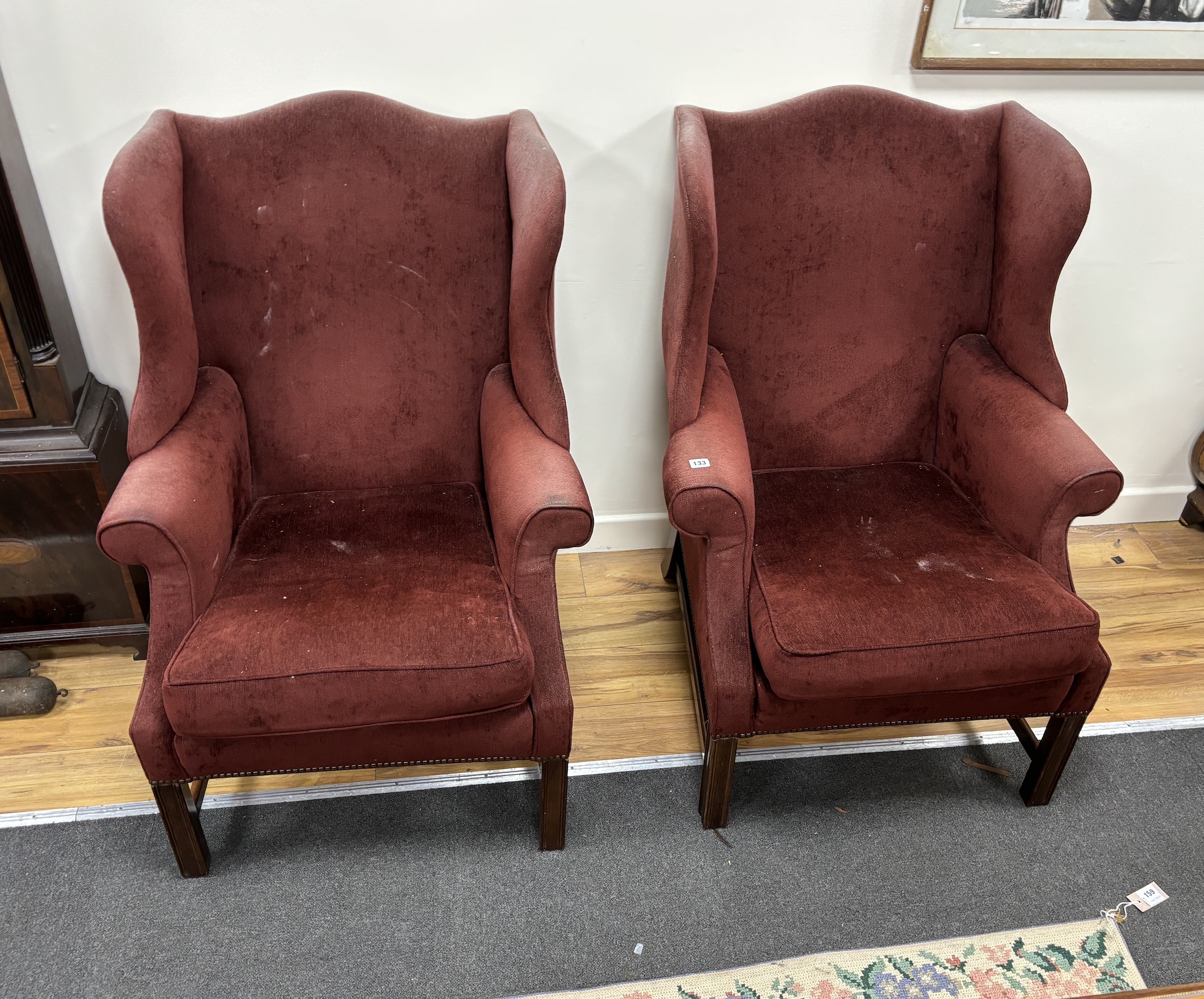 A pair of George III style upholstered wing armchairs, width 78cm, depth 80cm, height 105cm